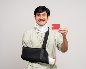 Happy young asian man broken arm on isolated background. Asian man put on plaster bandage cast...