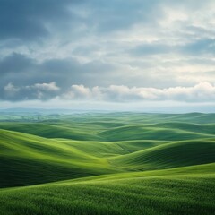 Fototapeta premium Serene, rolling hills of vibrant green pasture under a partly cloudy sky.