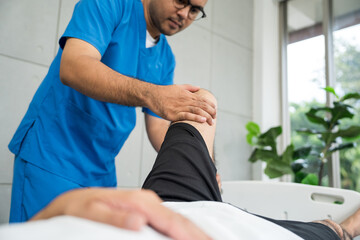 Obraz premium Physical therapy. Male Nurse aids young man in recovering from spine injury and providing orthopedic massage Orthopedic healthcare and chiropractor with person for physical therapy rehabilitation
