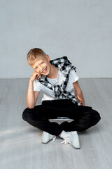 a teenage boy with a skateboard, a child boy on a white background, a space and a place for text, a child playing sports