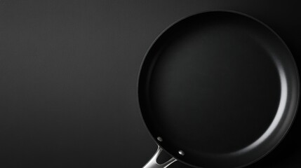 Non-stick frying pan on black surface.