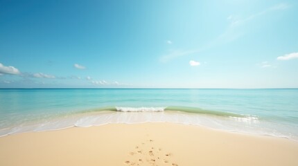 Fototapeta premium Golden sand and crystal-clear sea stretching to the horizon, under a bright blue sky, creating a peaceful tropical beach scene.