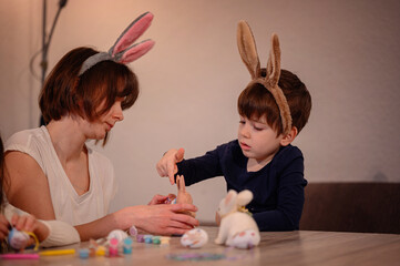 Naklejka premium Mother and Son Decorating Easter Crafts Together