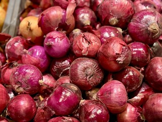  Pile of an large red onion sale in box in vegetable stand display at supermarket show organic food, vegetarian food, healthy food. Close-up