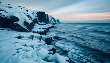 Fototapeta premium a rocky cliff covered in snow next to the ocean