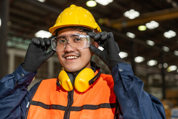 Close up technician engineer wearing and adjust protective safety glasses. Safety equipment for...