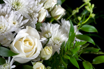 Floral Arrangement of White Flowers on a Black Background