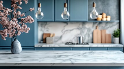 A beautifully designed marble kitchen island showcases clean lines and sleek surfaces. Elegant light bulbs illuminate the space, while vibrant blooms add a touch of nature and charm