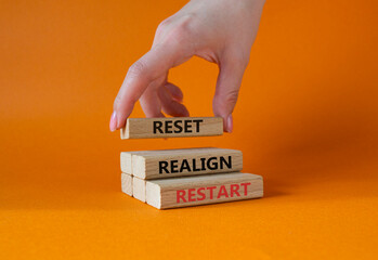 Reset Realign Restart symbol. Concept words Reset Realign Restart on wooden blocks. Businessman...