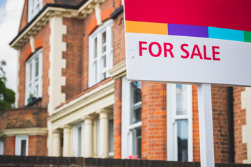 For Sale sign displayed outside a terraced house in Crouch End, London, UK