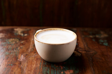 Cappuccino on dark wooden background. Soft focus. Close up.	