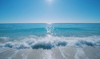 Fototapeta premium Serene ocean waves lapping a sandy shore under a bright sun