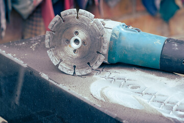 angle grinder with diamond saw on piece of granite. Stone workshop