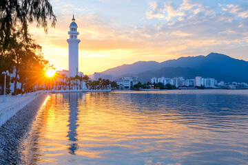 Fototapeta premium Coastal city sunset with lighthouse, reflecting in calm water; mountains in background. Ideal for travel brochures or tourism websites