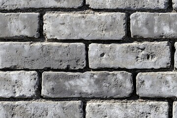 Fototapeta premium Seamless clean cinder block textured gray brick wall, showcasing the rough surface and irregularities of the bricks.