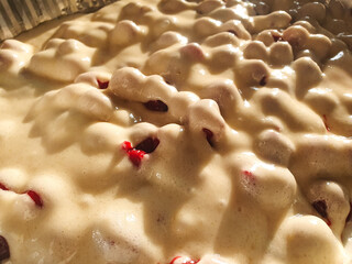 Liquid pie mix,cake mix in a mold. Filling of flour sweet biscuit with cherry.