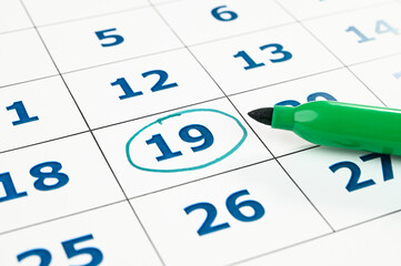 Marking date in a monthly planner.