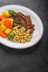 Vegetarian main course vegetables lentils, beans, potatoes, carrots tasty fresh delicious gourmet food background on the table rustic food top view copy space keto and paleo diet vegetarian and vegan 