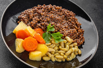 Vegetarian main course vegetables lentils, beans, potatoes, carrots tasty fresh delicious gourmet food background on the table rustic food top view copy space keto and paleo diet vegetarian and vegan 