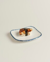 Elegant Sushi Piece on Minimalist Plate with Soft Neutral Background