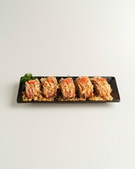 Fresh Delicious Sushi Rolls on Black Plate with Colorful Toppings