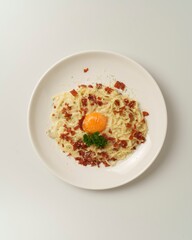 Creamy Pasta Plate with Egg Yolk and Crispy Bacon on White Background