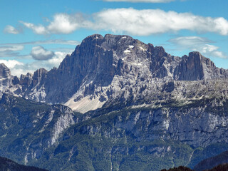 Aerial view beautiful Dolomite mountain Alps dawn range against blue sky on sunny day Italy. Top view drone of high rocks, mountain peaks. Tourism travel concept. Amazing nature scenery in Dolomites