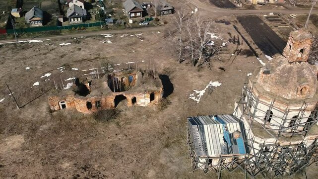 An old ruined brick church with an extension