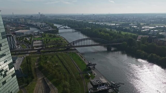 An aerial drone view of the Deutschherrnbr&uuml;cke in Frankfurt, Germany, showcasing the steel railway bridge that spans the River Main and connects the eastern part of the city with the Sachsenhausen dis