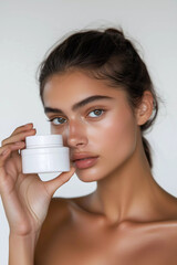 Skincare cosmetic beauty product, beautiful european woman with hydrated skin face holding moisturizing cream
