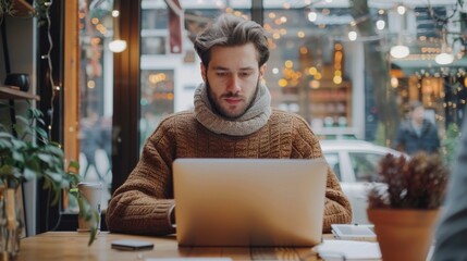 Obraz premium Freelancer working on laptop in cozy remote cafe during a busy day