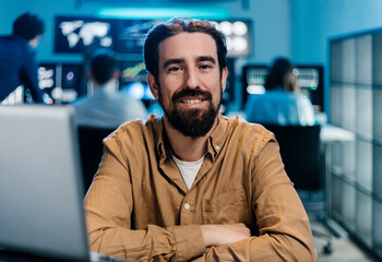 Fototapeta premium Portrait of a confident stock trader smiling with folded arms. Financial investment and technology concept