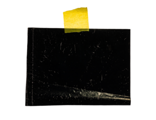 Scratched black film with yellow tape on a plain background showcasing grunge texture.