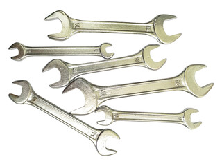 A collection of shiny metal wrenches scattered on a white background.  This image conveys concepts of repair, maintenance, DIY, and problemsolving.