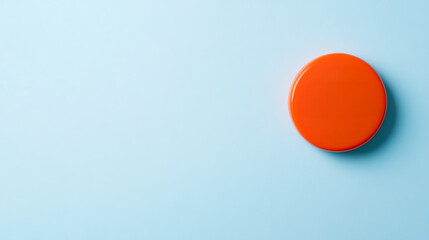 A vibrant orange circle sits on a light blue background, creating a minimalist and modern visual effect.