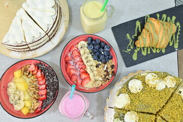 A table with a variety of desserts and drinks, including a cake, a pie