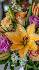 Fototapeta premium Vibrant mixed flower bouquet including lilies, roses, and lush greenery.