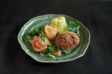 A plate of food with a green plate and a red tomato