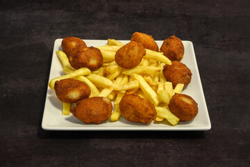 A plate of fried chicken and french fries