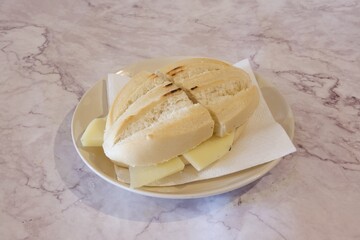 A sandwich is on a plate with a napkin underneath it