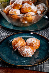 Small doughnuts with powdered sugar.