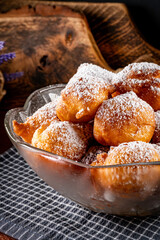 Small doughnuts with powdered sugar.