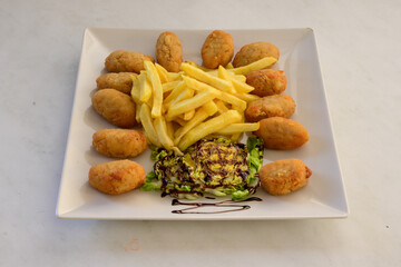 A plate of fried chicken and french fries