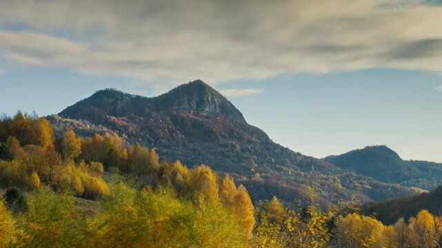 The warm hues of fall contrast with the rugged slopes of the majestic highlands