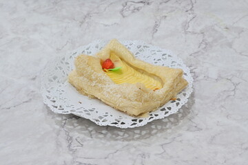 A pastry with a green leaf on top of it