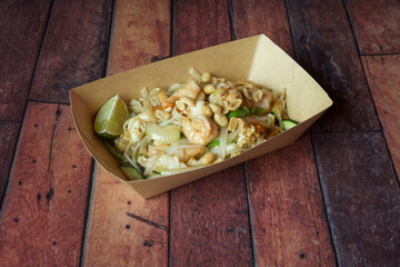 A tray of food with shrimp and lime