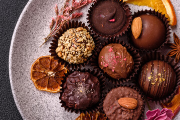 Homemade chocolate candies with different fillings and sprinkles