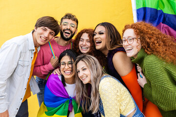 LGBT young group of people having fun with rainbow flag during gay pride day festival. LGBTI...