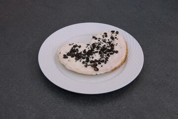 A white plate with a cookie on it