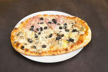 A pizza with olives, mushrooms, and cheese on a white plate